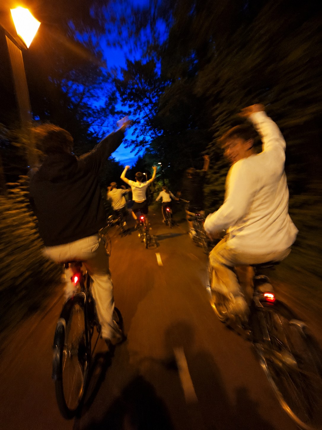 Friends riding bikes at night